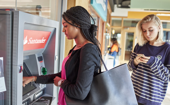Student at a cashpoint on campus