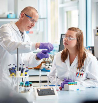 A student and lecturer in a lab