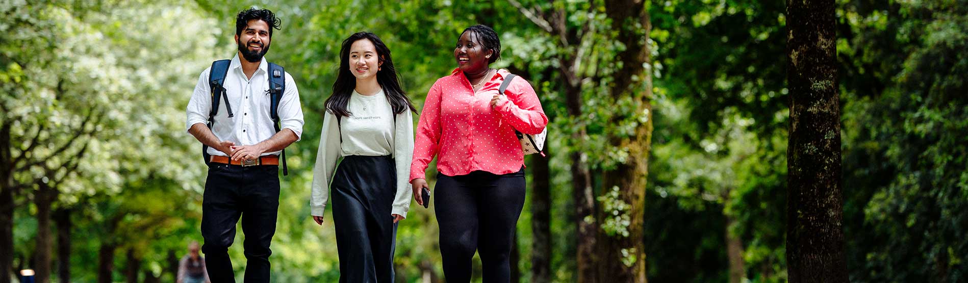 A group of Swansea University students walking into campus