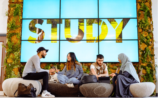Four students discussing in a relaxed environment. 